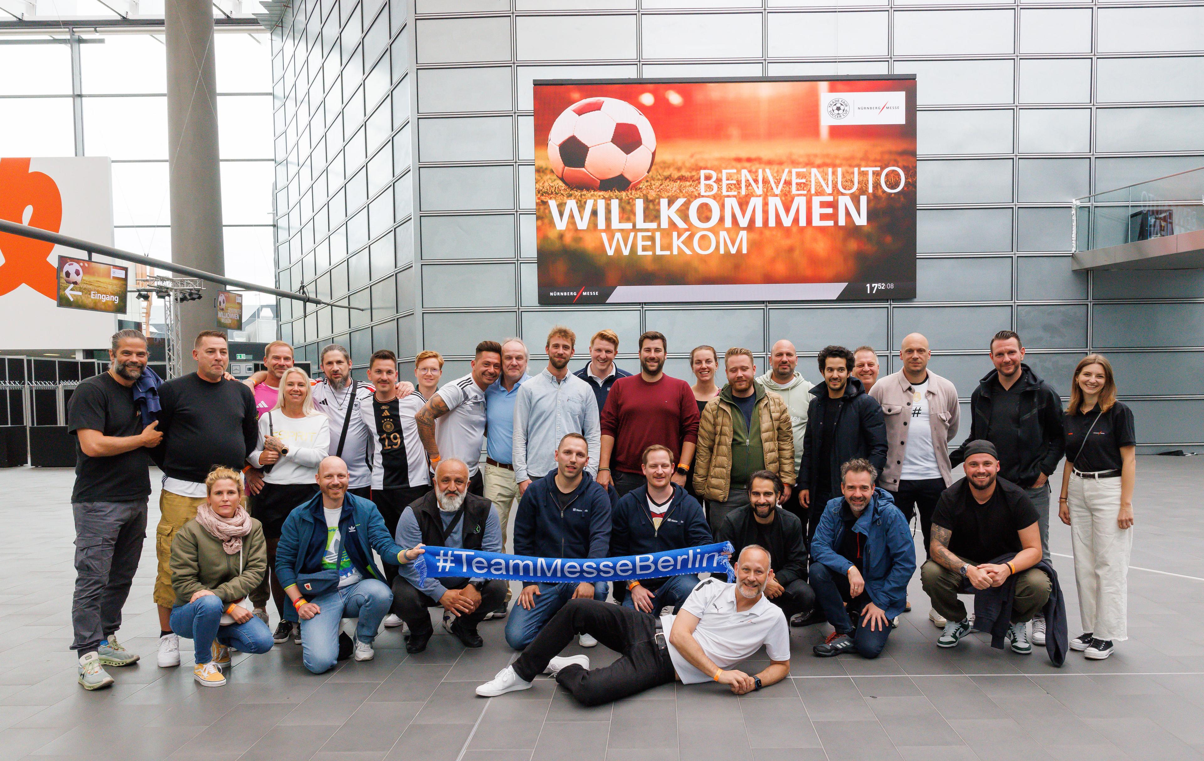 Messe Berlin-Fußballteam im Eingang Süd vor einem Display auf dem EM-Footage abgespielt wird